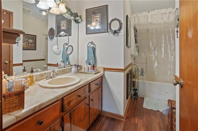 full bathroom with shower / tub combo, wood finished floors, vanity, and a notable chandelier