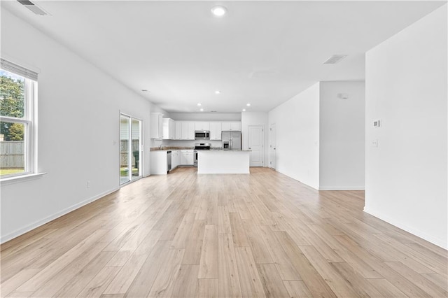 3660 Cattle Field Xing, Loganville, GA 30052 - unfurnished living room featuring light wood finished floors and recessed lighting