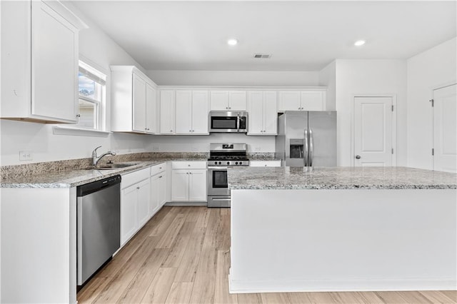 3660 Cattle Field Xing, Loganville, GA 30052 - kitchen featuring stainless steel appliances, white cabinetry, light wood-type flooring, and recessed lighting