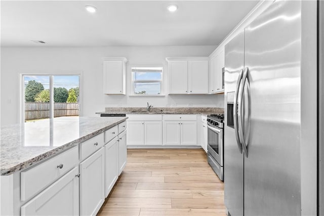 3660 Cattle Field Xing, Loganville, GA 30052 - kitchen with appliances with stainless steel finishes, plenty of natural light, recessed lighting, and white cabinets