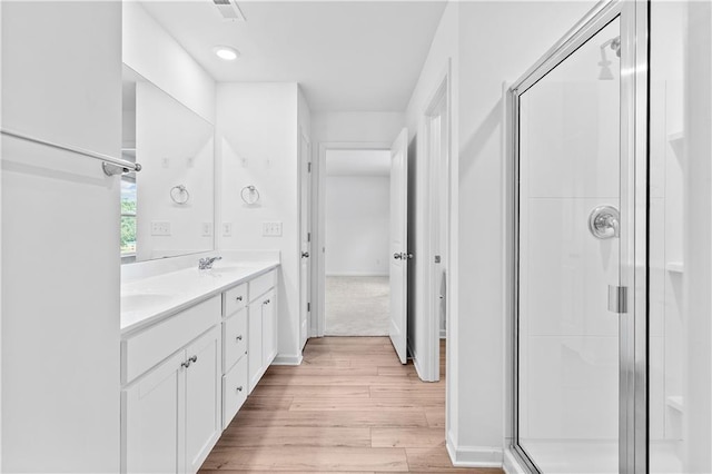 3660 Cattle Field Xing, Loganville, GA 30052 - bathroom featuring wood finished floors, double vanity, and a stall shower
