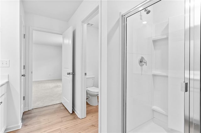 3660 Cattle Field Xing, Loganville, GA 30052 - bathroom with wood finished floors, a shower stall, and vanity