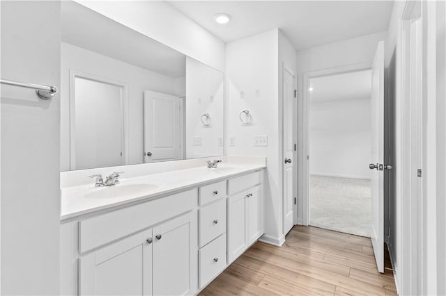 3660 Cattle Field Xing, Loganville, GA 30052 - bathroom featuring double vanity, wood finished floors, and recessed lighting