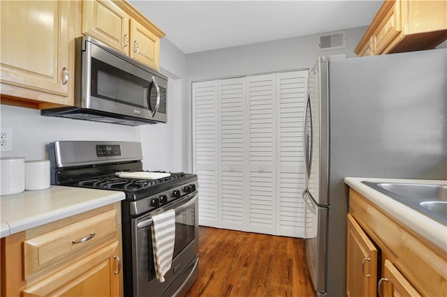 unfurnished bedroom featuring ceiling fan, multiple windows, dark wood-type flooring, and a closet