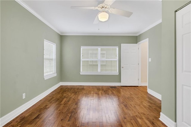 empty room featuring hardwood / wood-style flooring, ceiling fan, and crown molding