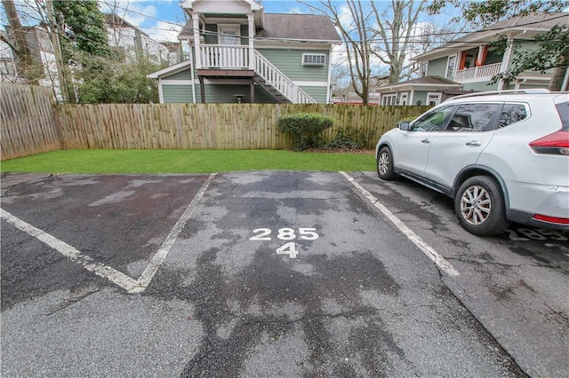 view of parking / parking lot featuring a lawn