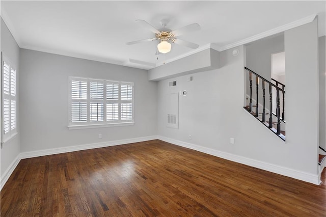 empty room featuring a wealth of natural light, crown molding, and dark hardwood / wood-style floors