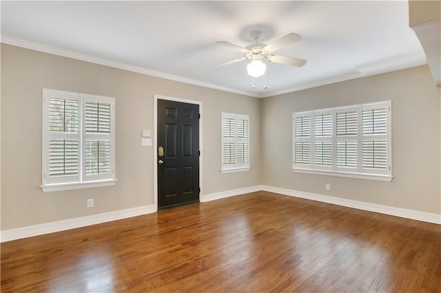 entryway with dark hardwood / wood-style floors, ceiling fan, and ornamental molding