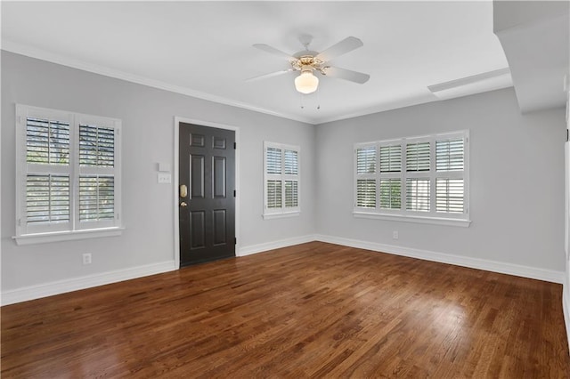 entrance foyer featuring crown molding, ceiling fan, dark hardwood / wood-style flooring, and a wealth of natural light