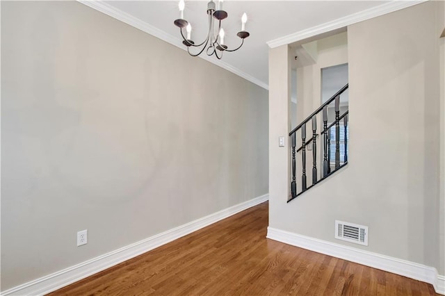 interior space featuring crown molding, a chandelier, and wood-type flooring