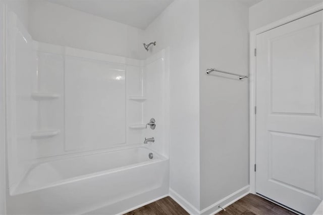 bathroom with hardwood / wood-style flooring and shower / bath combination