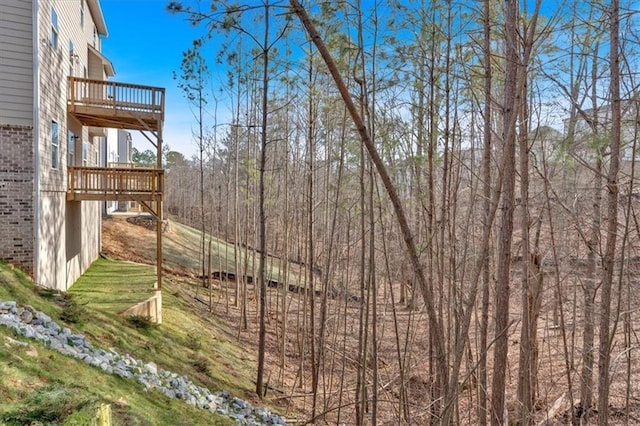 view of yard featuring a balcony and a deck