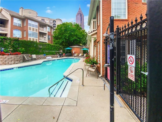 200 Renaissance Pkwy NE Unit 302, Atlanta, GA 30308 - pool featuring a patio area and fence