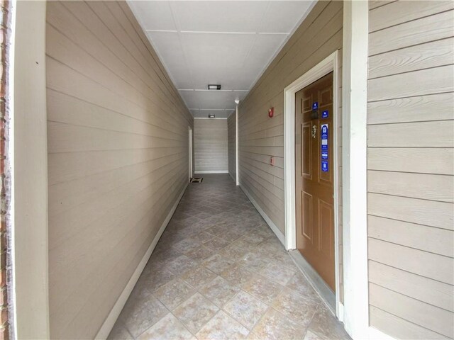 hallway with wood walls