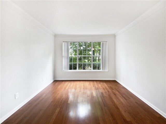 unfurnished room featuring crown molding and dark hardwood / wood-style floors