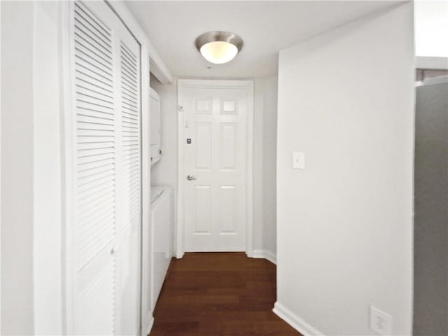 200 Renaissance Pkwy NE Unit 302, Atlanta, GA 30308 - hall featuring dark wood finished floors, stacked washing maching and dryer, and baseboards