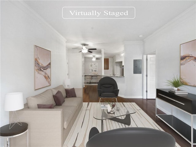 living room featuring hardwood / wood-style floors, ceiling fan, and ornamental molding