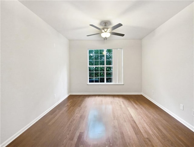 empty room with ceiling fan and hardwood / wood-style flooring