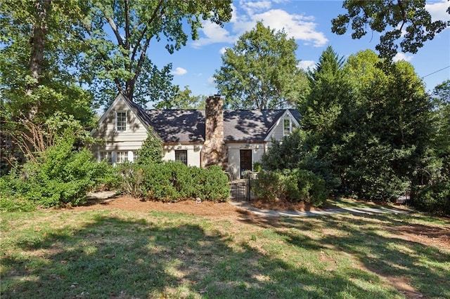 view of front facade with a front lawn and a chimney