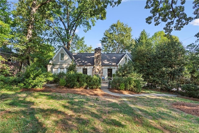 view of front of property with a front lawn and a chimney