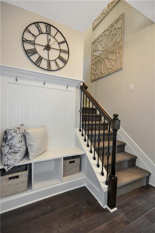mudroom featuring dark wood-style floors and baseboards