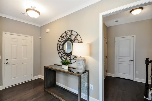 foyer with wood finished floors, baseboards, and crown molding