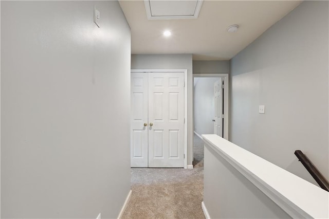 corridor featuring light carpet, an upstairs landing, baseboards, and recessed lighting
