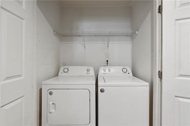 washroom with washing machine and clothes dryer