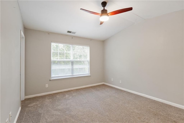 empty room with carpet floors, a ceiling fan, baseboards, and lofted ceiling