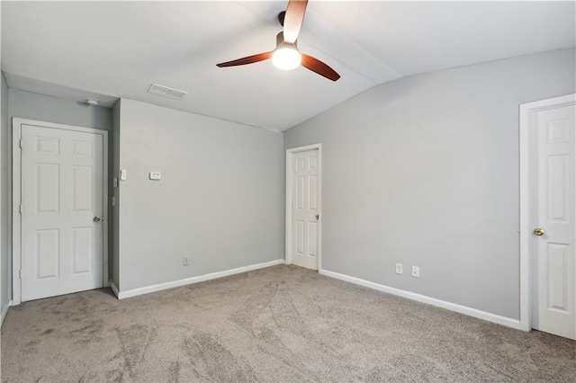 unfurnished bedroom featuring lofted ceiling, carpet floors, baseboards, and ceiling fan