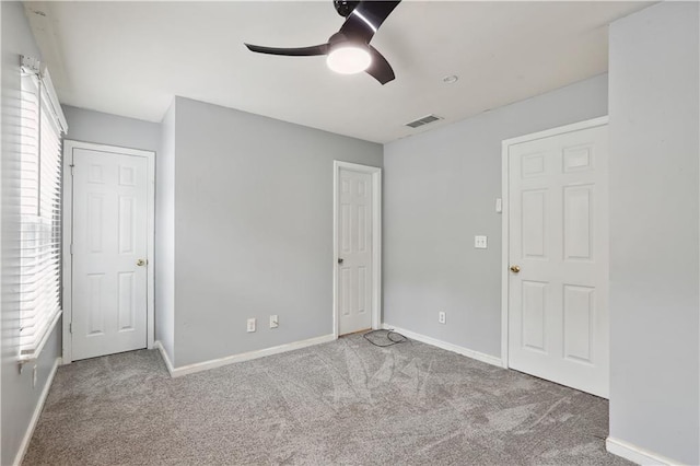 unfurnished bedroom with carpet floors, baseboards, and ceiling fan