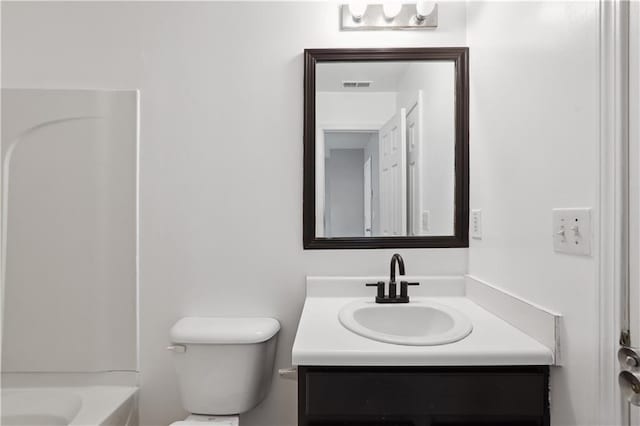 bathroom featuring toilet and vanity