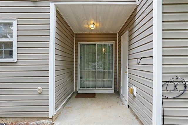 view of exterior entry featuring a patio area