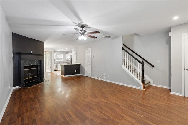 unfurnished living room with baseboards, ceiling fan, dark wood finished floors, and recessed lighting