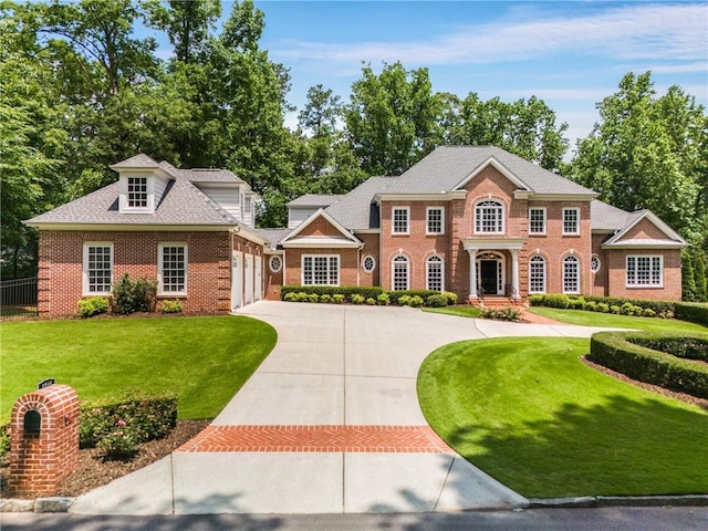 1655 Arrowhead Trl NE, Atlanta, GA 30345 - colonial house featuring brick siding, concrete driveway, a garage, and a front lawn