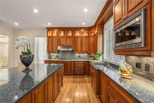 1655 Arrowhead Trl NE, Atlanta, GA 30345 - kitchen with appliances with stainless steel finishes, a sink, under cabinet range hood, light wood-type flooring, and brown cabinets