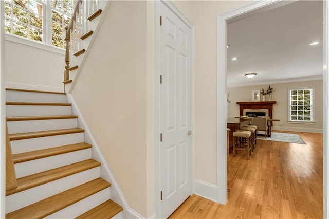 1655 Arrowhead Trl NE, Atlanta, GA 30345 - staircase with baseboards, wood finished floors, crown molding, a fireplace, and recessed lighting
