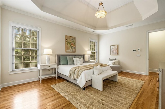 1655 Arrowhead Trl NE, Atlanta, GA 30345 - bedroom featuring a tray ceiling, ornamental molding, baseboards, and light wood-type flooring