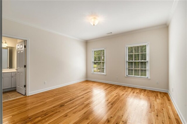 1655 Arrowhead Trl NE, Atlanta, GA 30345 - unfurnished room with light wood-style floors, crown molding, and baseboards