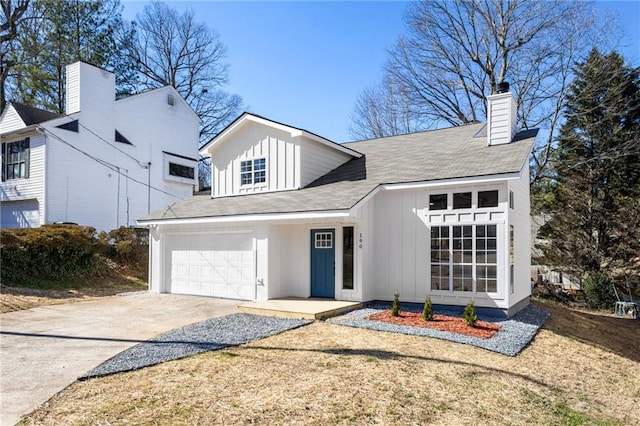 view of front of house featuring driveway, board and batten siding, and an attached garage