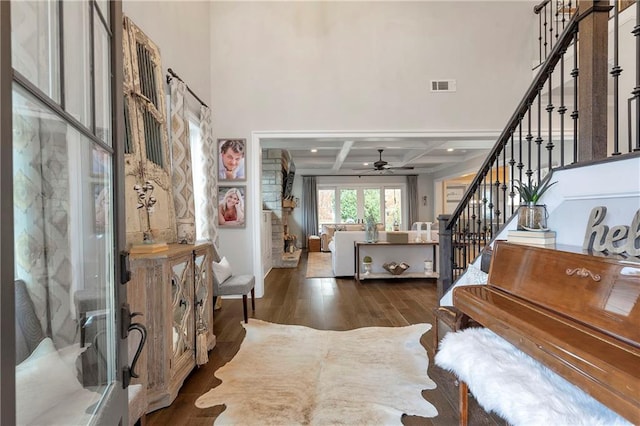 foyer featuring beamed ceiling, dark hardwood / wood-style floors, ceiling fan, and coffered ceiling