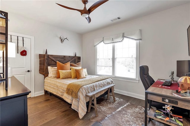 bedroom with dark hardwood / wood-style flooring and ceiling fan