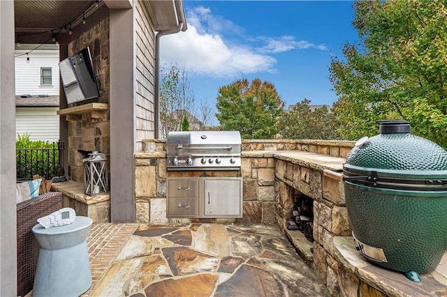 view of patio / terrace featuring an outdoor kitchen and a grill