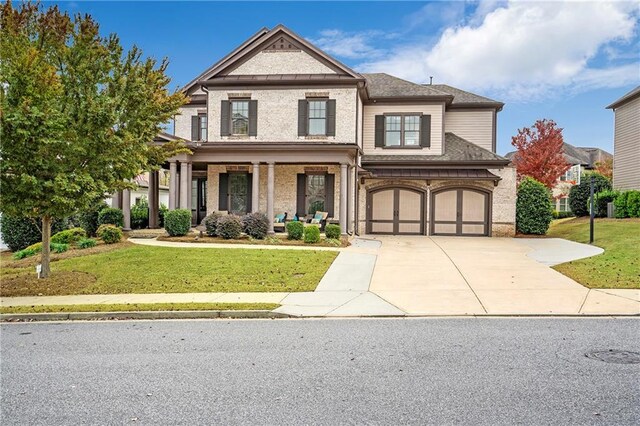 view of front of property with a garage and a front lawn