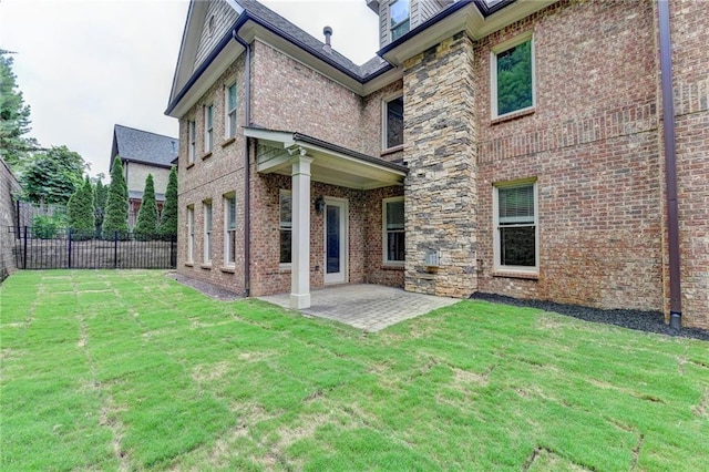 rear view of property with a patio area and a yard