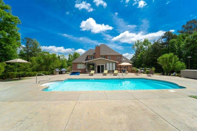 view of pool featuring a patio and an outdoor structure