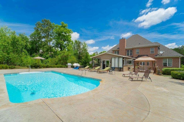 view of swimming pool with a gazebo, an outdoor structure, and a patio