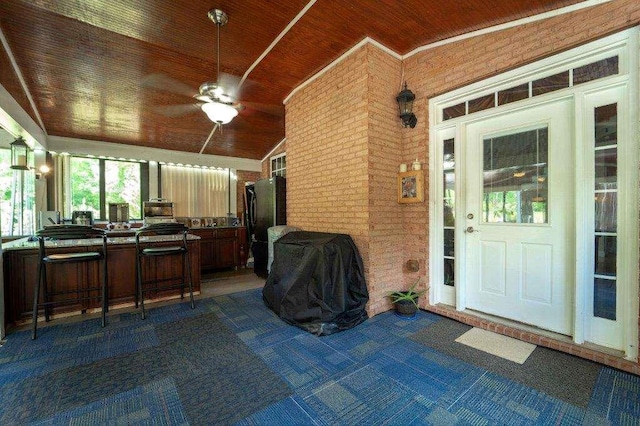 entrance to property featuring a bar and ceiling fan