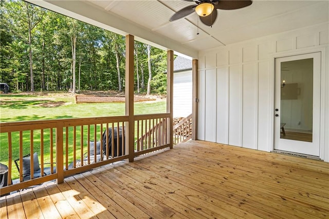 deck with a yard and ceiling fan