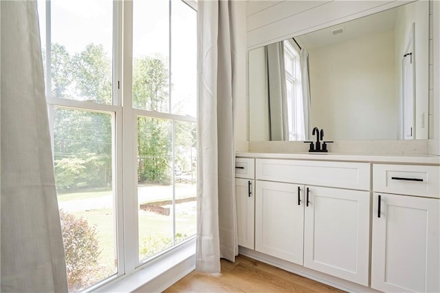 bathroom featuring vanity and hardwood / wood-style flooring